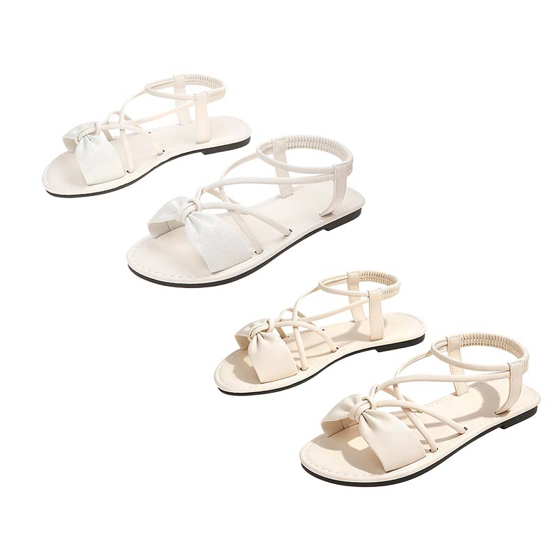 Platta sandaler med korsade remmar för damer