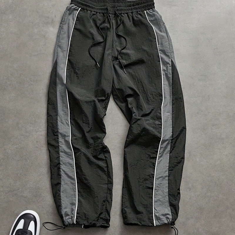 Snabborkande träningsbyxor för herr med sidoränder