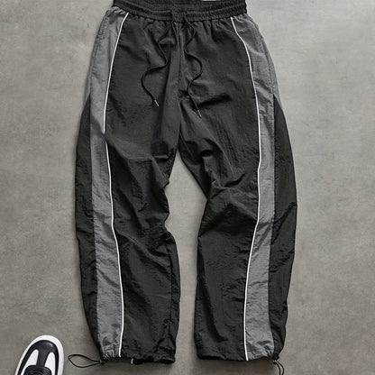 Snabborkande träningsbyxor för herr med sidoränder