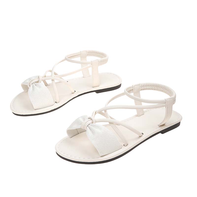 Platta sandaler med korsade remmar för damer