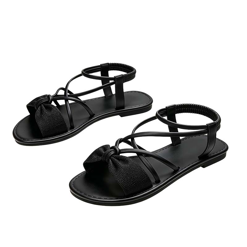 Platta sandaler med korsade remmar för damer