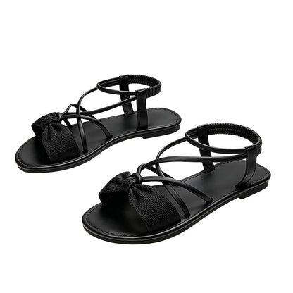 Platta sandaler med korsade remmar för damer