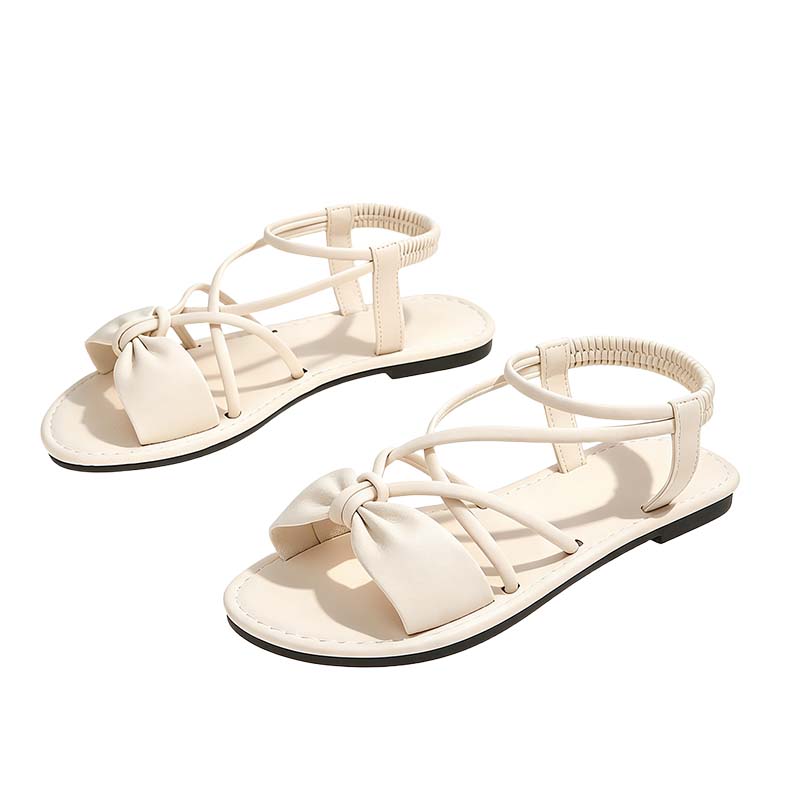 Platta sandaler med korsade remmar för damer