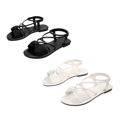 Platta sandaler med korsade remmar för damer